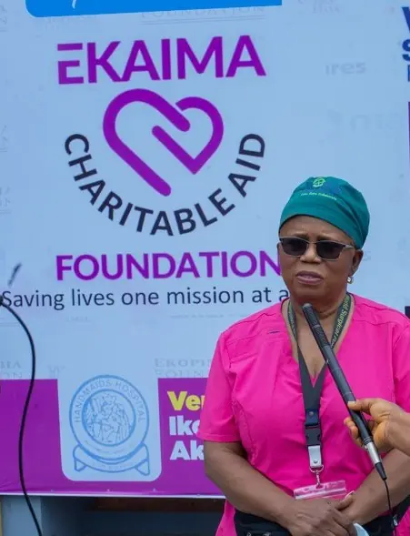 Volunteers serving hot meals to children.